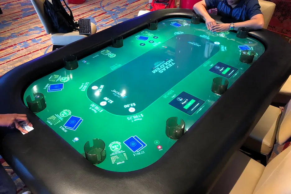 Players playing Texas Hold’em on an electronic poker table
